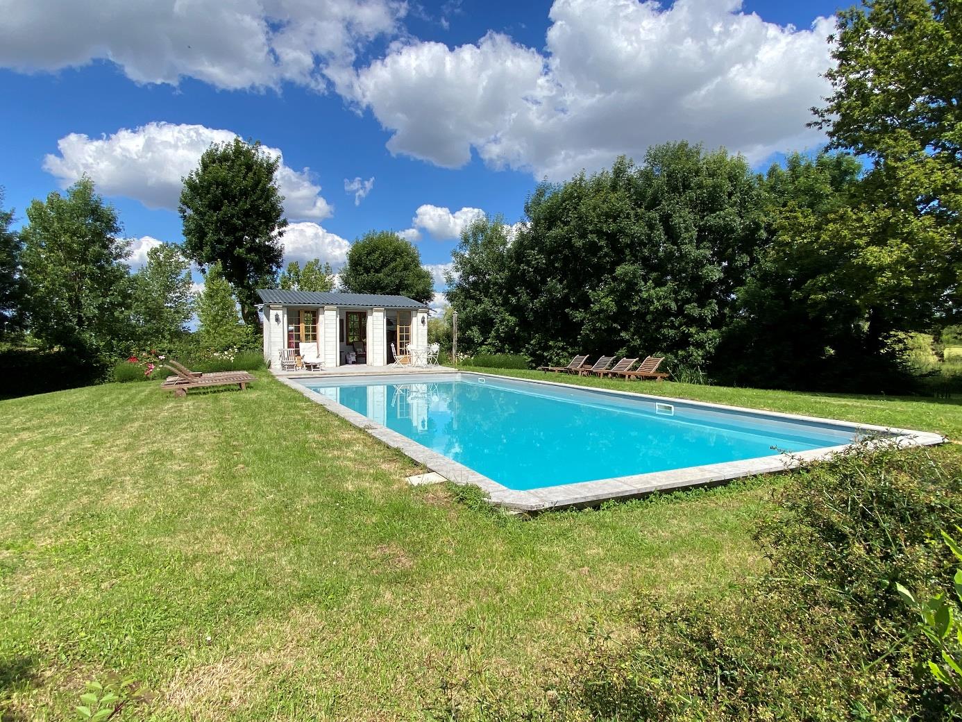 Swimming pool and pool house in the parkland